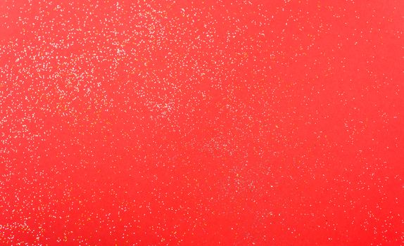 Shiny particles glitter on red background Christmas decorative with copy space