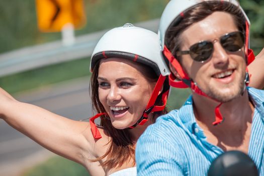 Happy couple on a scooter at summer vacation