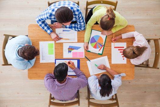 Business team meeting, people in casual clothes working with financial statistics at office desk