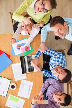 Business team meeting, people in casual clothes working with financial statistics at office desk showing thumbs up