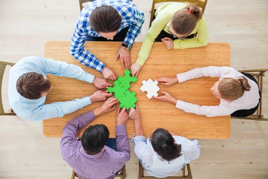 Hipster business successful teamwork concept, business people group assembling jigsaw puzzle, top view