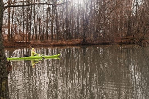 The girl floats on the river in a kayak.A girl on a kayak.