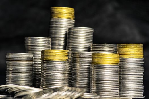 A lot of coins, selective focus.Front view of stacks of Euro coins.Concept photo.Coins close-up on the table. Simple and minimalistic design .