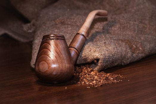 Wooden Pipe and Tobacco design.Over Black background