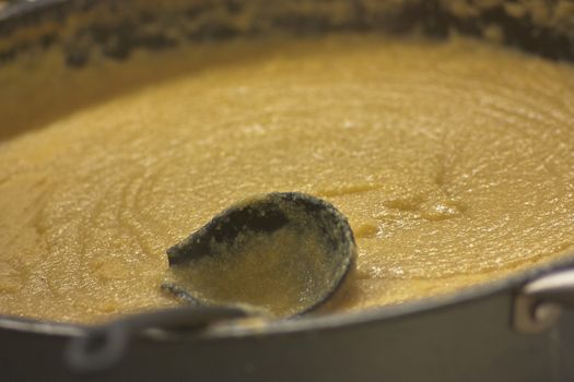 Cooking pot of polenta that lasts several hours.