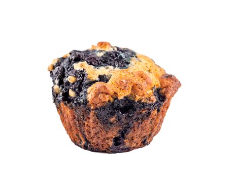 Homemade vegan blueberry muffin isolated. Vegetarian egg-free muffin with blue berries isolated on whte with clipping path.