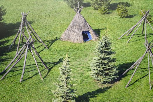 Wigwam type thatch huts .Straw wigwam on a glade on a sunny spring day.Outdoor recreation. Real nature.