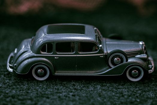 Car close-up.Dark grey vintage car . Retro car's close up.Retro car on a dark background. Car close-up.