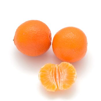 two Mandarin and one half isolated on white background