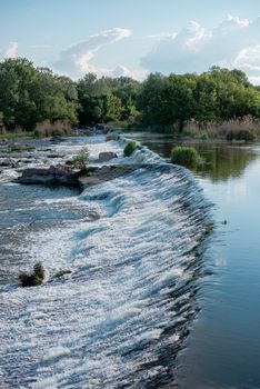 Power station dam on the Southern Bug River near the village of Migiya, Ukraine, on a sunny summer day