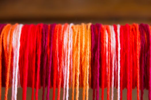 textured background of colored yarn on the loom