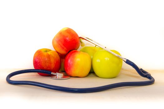 health concept with green and red apples and stethoscope