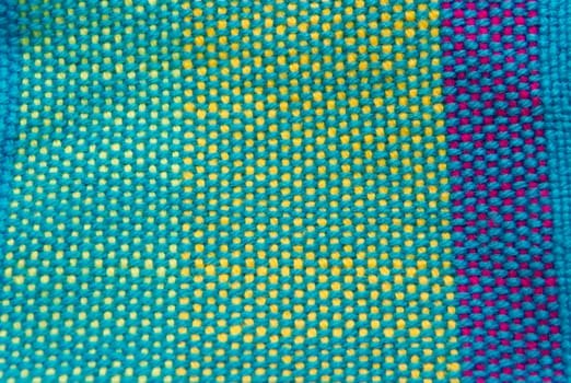 colorful background texture of weaving on loom