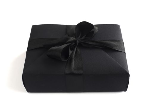 Black friday gift, paper box with silk ribbon bow isolated on white background