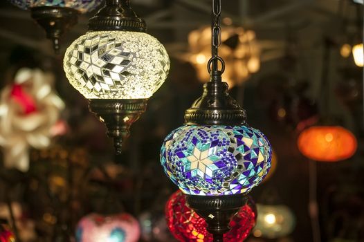 Detail of a beautiful vintage chandelier inlaid with lots of colored glasses.