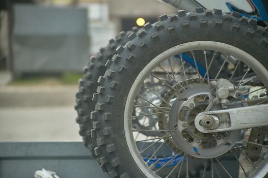 Wheel of a cross (or enduro) motorcycle with unpaved tires for better traction on difficult terrain.