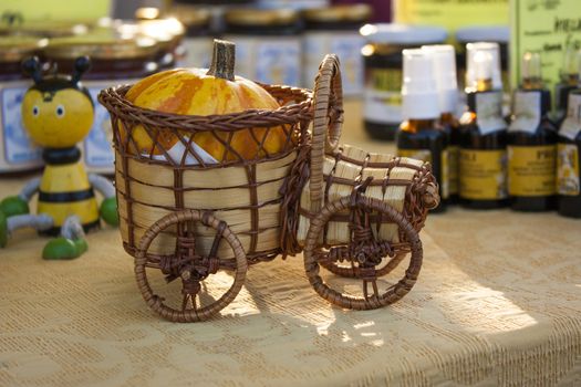 Model of a wooden and wicker car used as decoration in a market stand.