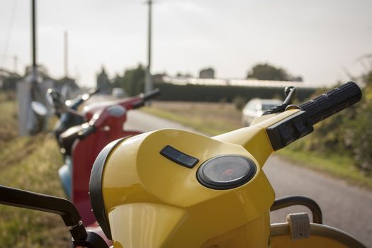 First-person photo of a yellow scooter, seeing how it is to drive a scooter.