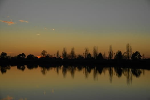 The lake landscape in autumn seen at dusk.