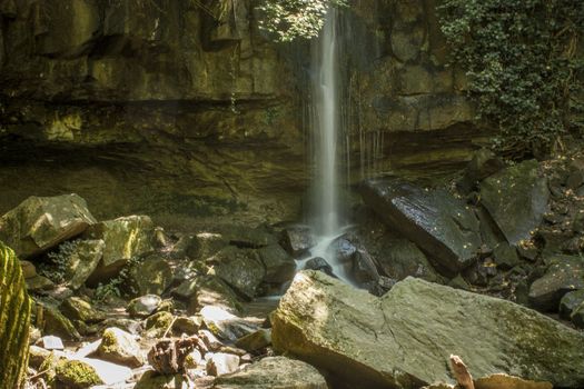 View of a waterfall (namely the Scivanoia waterfalls in Teolo Italy) in its summer period.