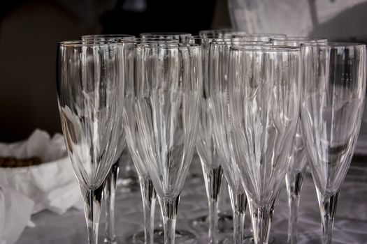 Table full of crystal glasses ready for the party and used to serve drinks.