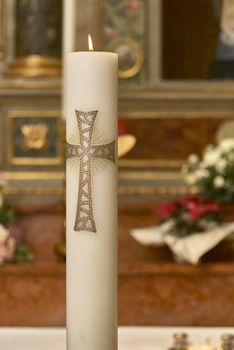 Large lit Easter candle used as a religious object in churches for various types of celebrations.