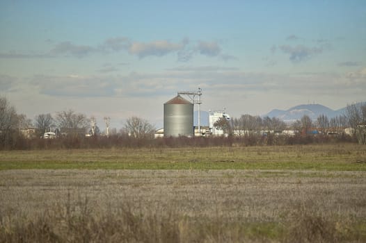 Dryer immersed in a countryside landscape with bare trees during the winter.