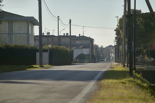 View of the panorama of an empty street in the center of a small village in northern Italy.