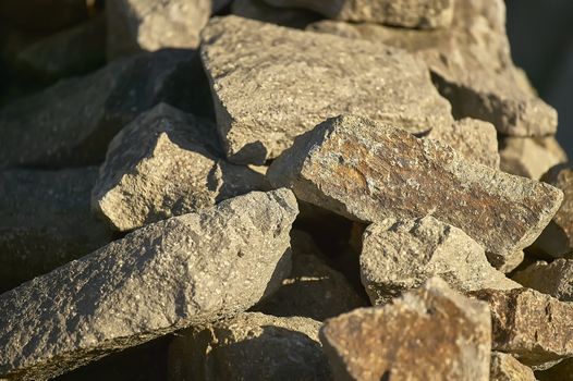 Group of rocks illuminated by the setting sun: ideal image as a background for graphic projects.