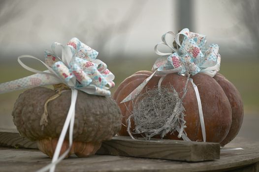 Two pumpkins decorated with blue flakes used as decoration for a catholic baptism.