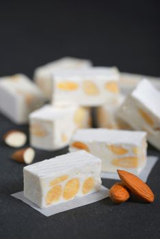 White nougat with almonds on black ardesia plate