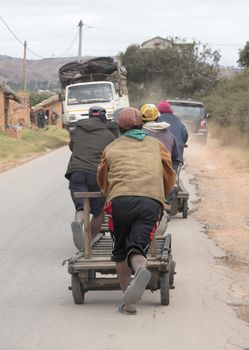 Men pushing an old cart on Madagascar, Africa