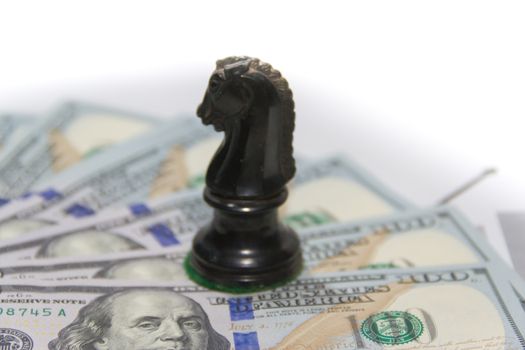 finance concept with dollar bills and chess horse
