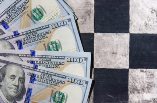 finance concept with dollar bills on chessboard
