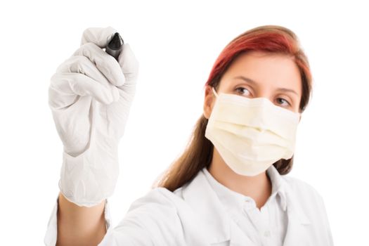 Young female health care professional or doctor or nurse with surgical mask writing on a virtual screen facing the camera, isolated on white background. Medical information concept. Research and development concept.