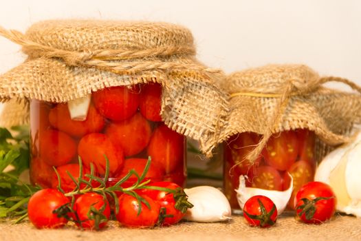 pickled cherry tomatoes in vinegar with garlic and spices