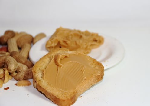 toast with peanut butter on white background