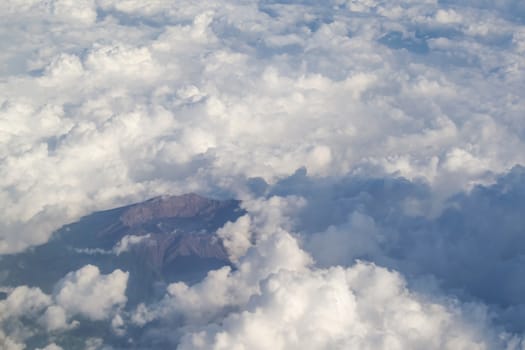 The sky with beautiful white clouds and mountain taken on airplane
