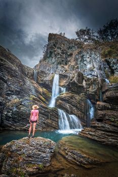 Waterfalls tumbling from over and within imposing rocky limestone gorge and caves flow into stunning blue swimming holes.  Moody weather of the Snowy Mountains rumbles overhead