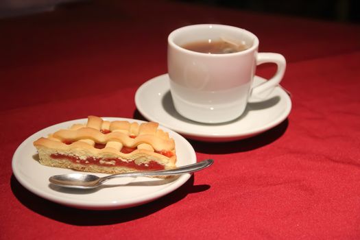 cup of tea with cake served on the table