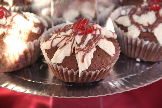 delicious cupcakes and muffins with chocolate and cherries