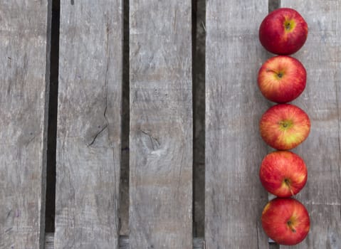 red apples on rustic wooden background