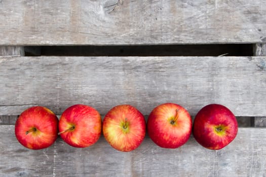 red apples on rustic wooden background