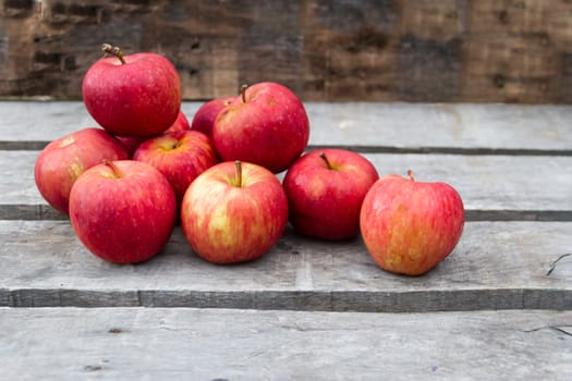 red apples on rustic wooden background