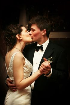 Romantic moment between bride and groom kissing celebrating their wedding day