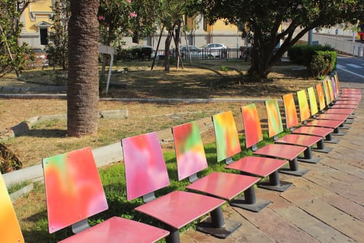 colorful benches lined up in the city center