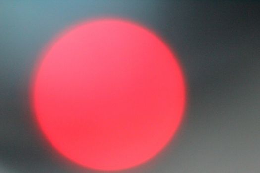 Defocused lights, red lens flare. Abstract blured background.