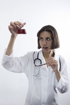 Doctor woman with stethoscope and flask on a white background