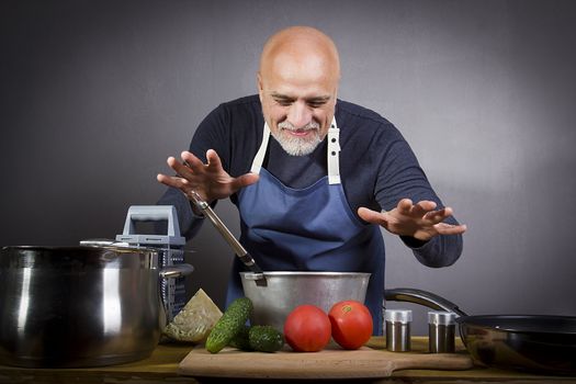 Waist up portrait of bearded senior man cooking at home and looking at camera while posing confidently in kitchen, copy space