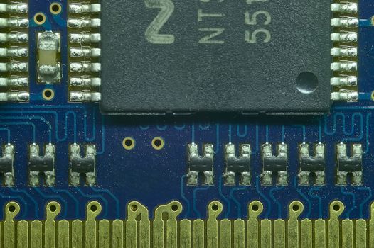 Welding of the pins of a microprocessor to the electronic board in macro shot with very high definition.